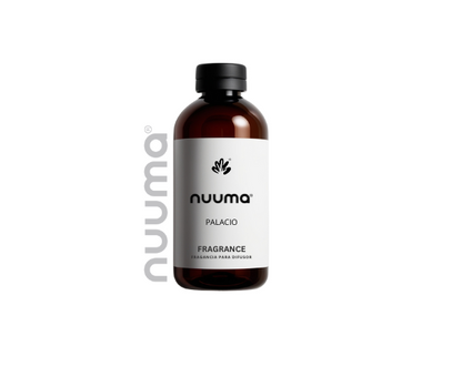 Fragancia para difusor Nuuma Palacio en frasco de vidrio ámbar con etiqueta blanca sobre fondo neutro.